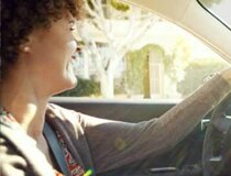 A profile shot of a woman driving.